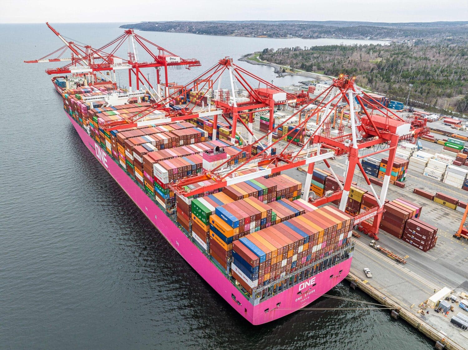 Container ship being unloaded by gantry cranes at the Port of Halifax on the Atlantic coast of Nova Scotia